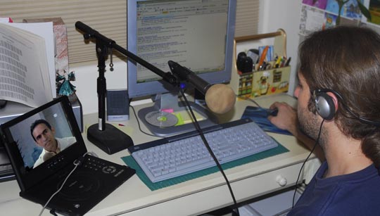 Dimitri translates and records while listening to Professor Paz on DVD.